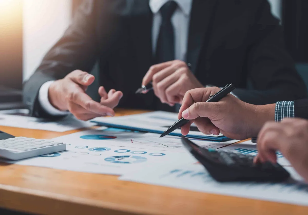 Colleagues reviewing figures together around a conference table